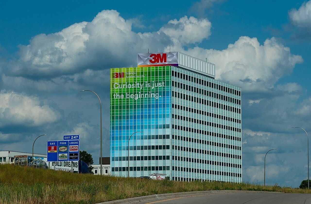 3M: White tower with a colorful banner and the 3M sign