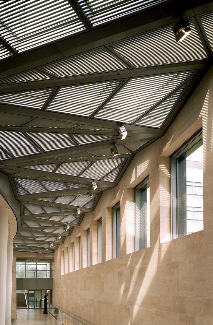 ABN AMRO: Long corridor with a sloping steel roof and stone walls