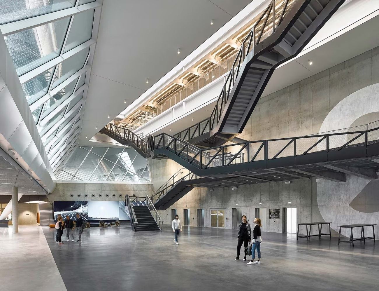 adidas: Atrium with criss-crossing black stairs under a skylight