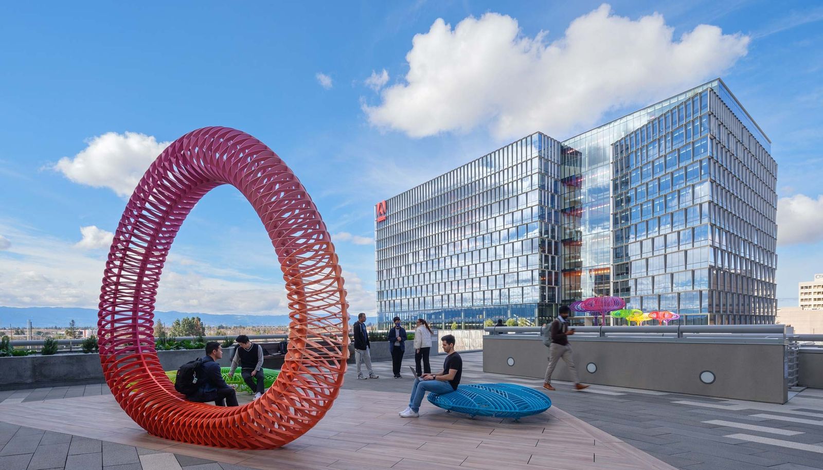 Adobe: A red ring sculpture on a roof terrace