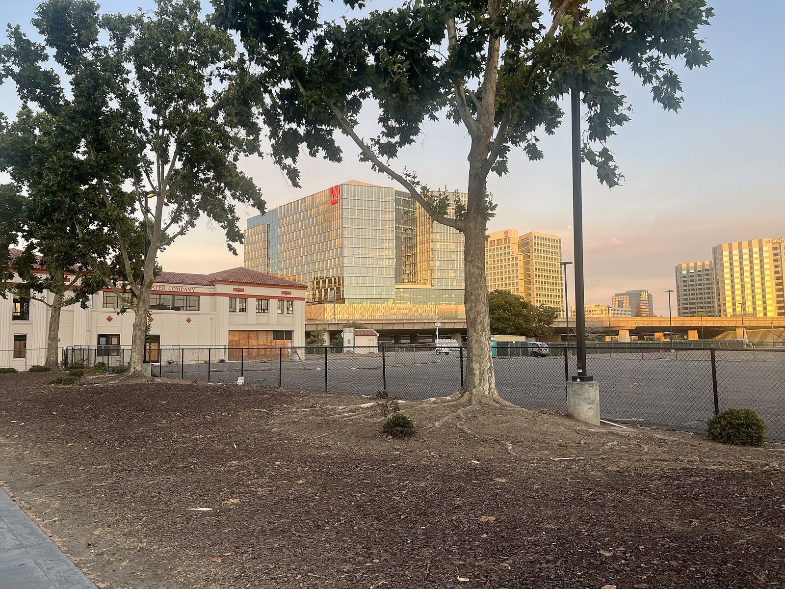 Adobe: Adobe's towers at sunset over an open lot