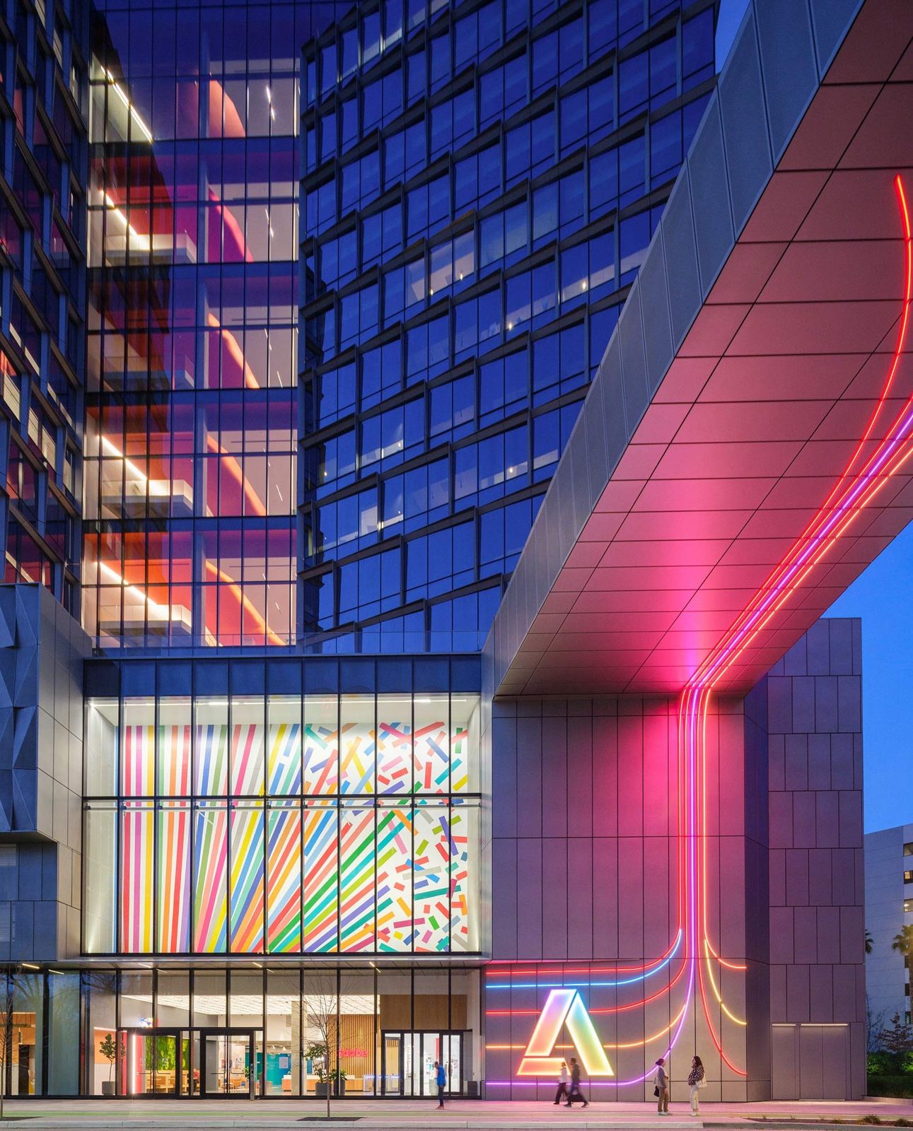 Adobe: The base of Founders Tower lit in rainbow colors