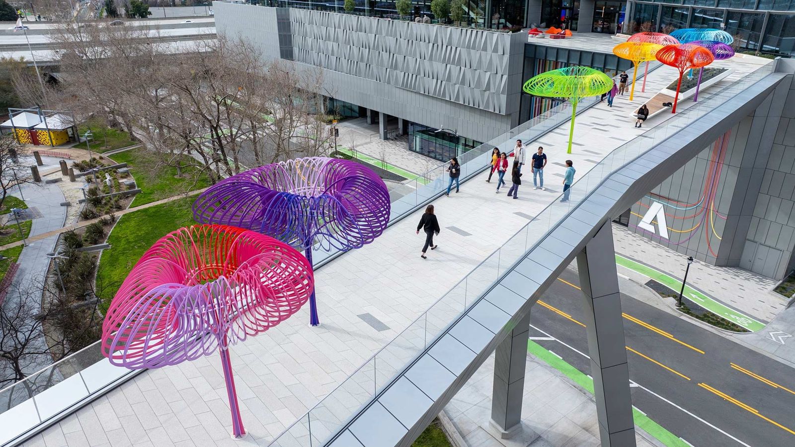 Adobe: The sky bridge with colorful sculptures over the street
