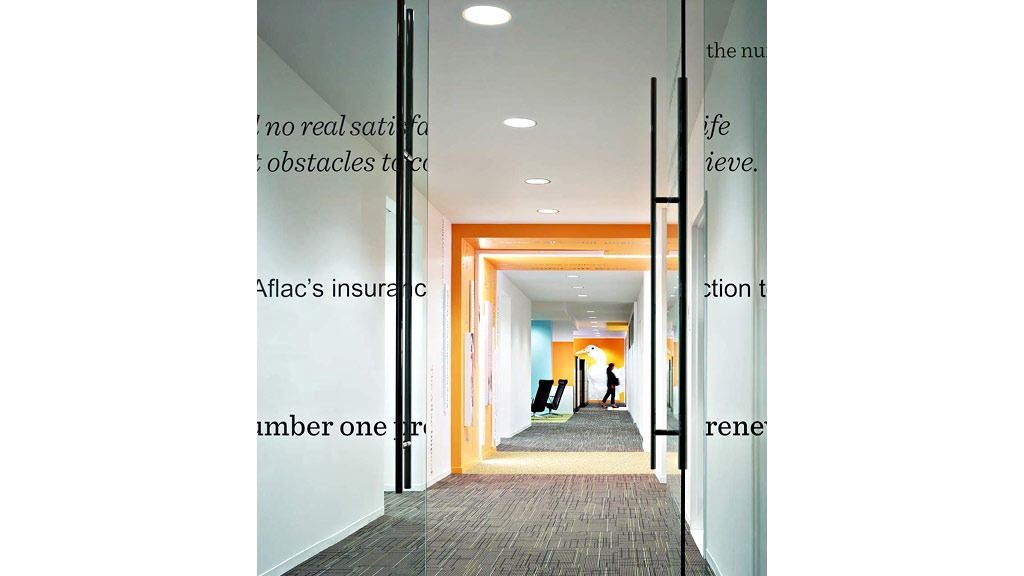 Aflac: A glass door etched with words leading to an orange-lit corridor
