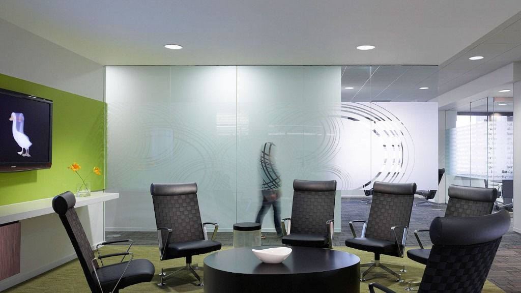 Aflac: Meeting chairs around a table under screens and frosted glass