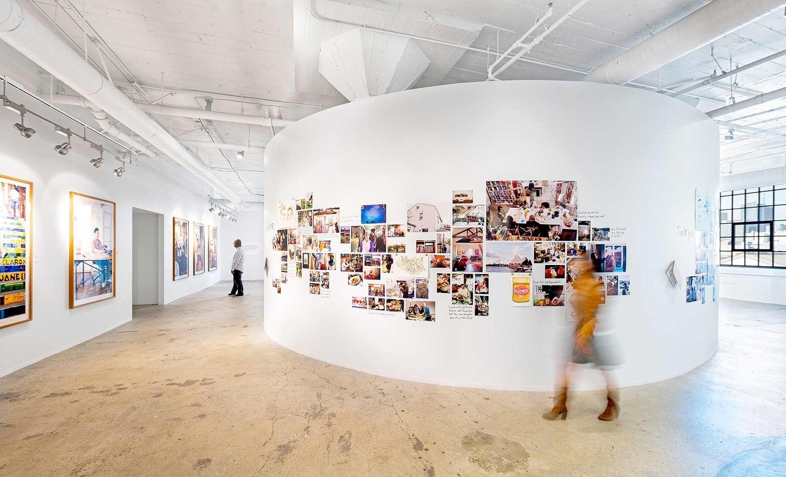 Airbnb: A curved white wall covered in travel photos