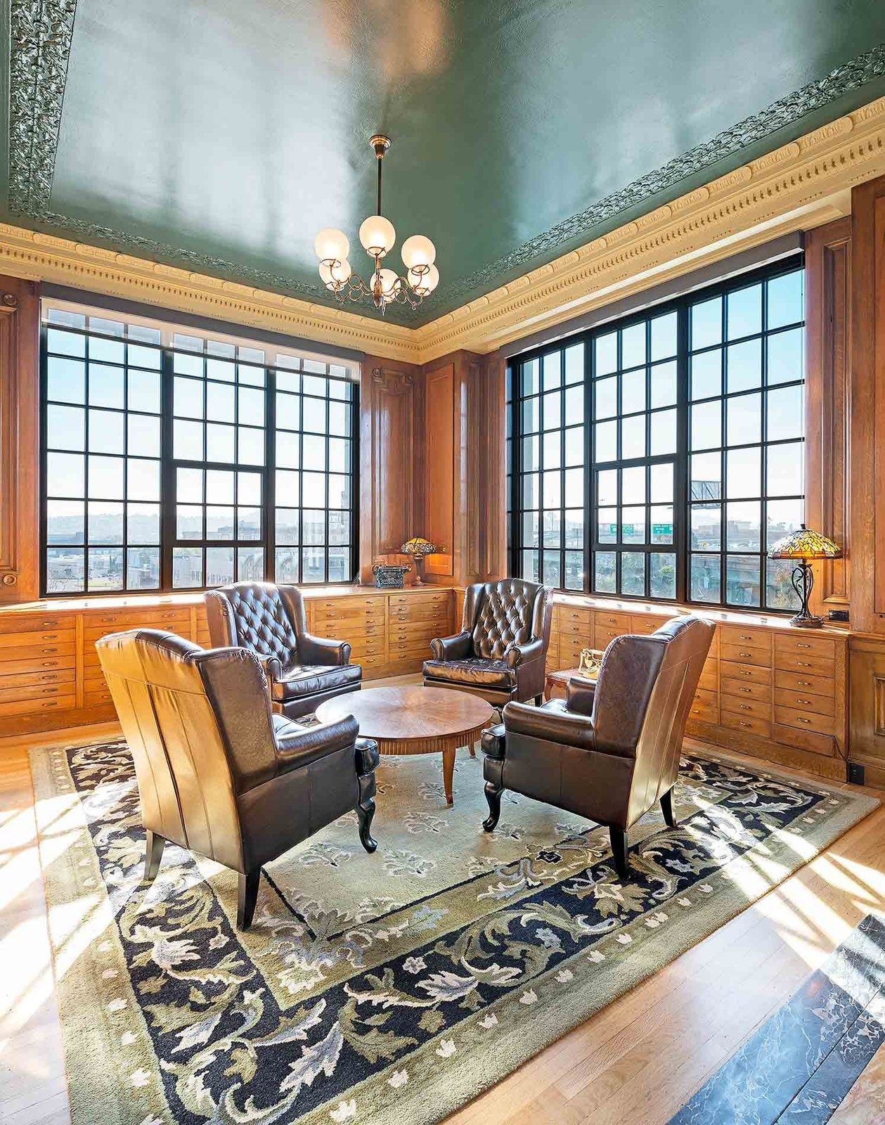 Airbnb: A meeting room styled as a wood-paneled study with leather armchairs