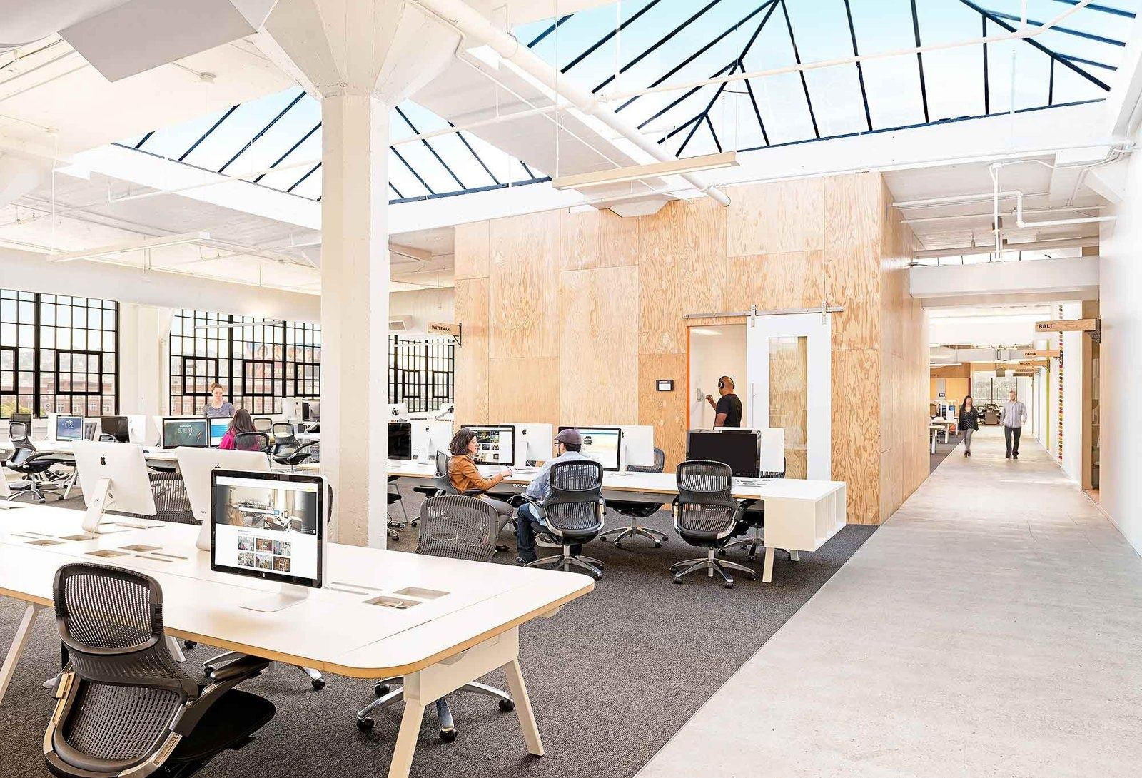 Airbnb: Open desks under a skylight with plywood rooms