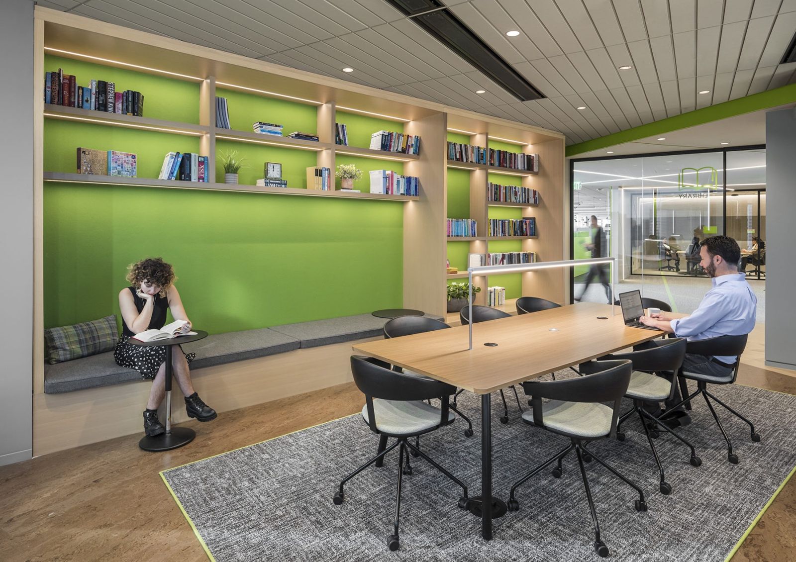 Akamai: A green library wall with shelves and a long table