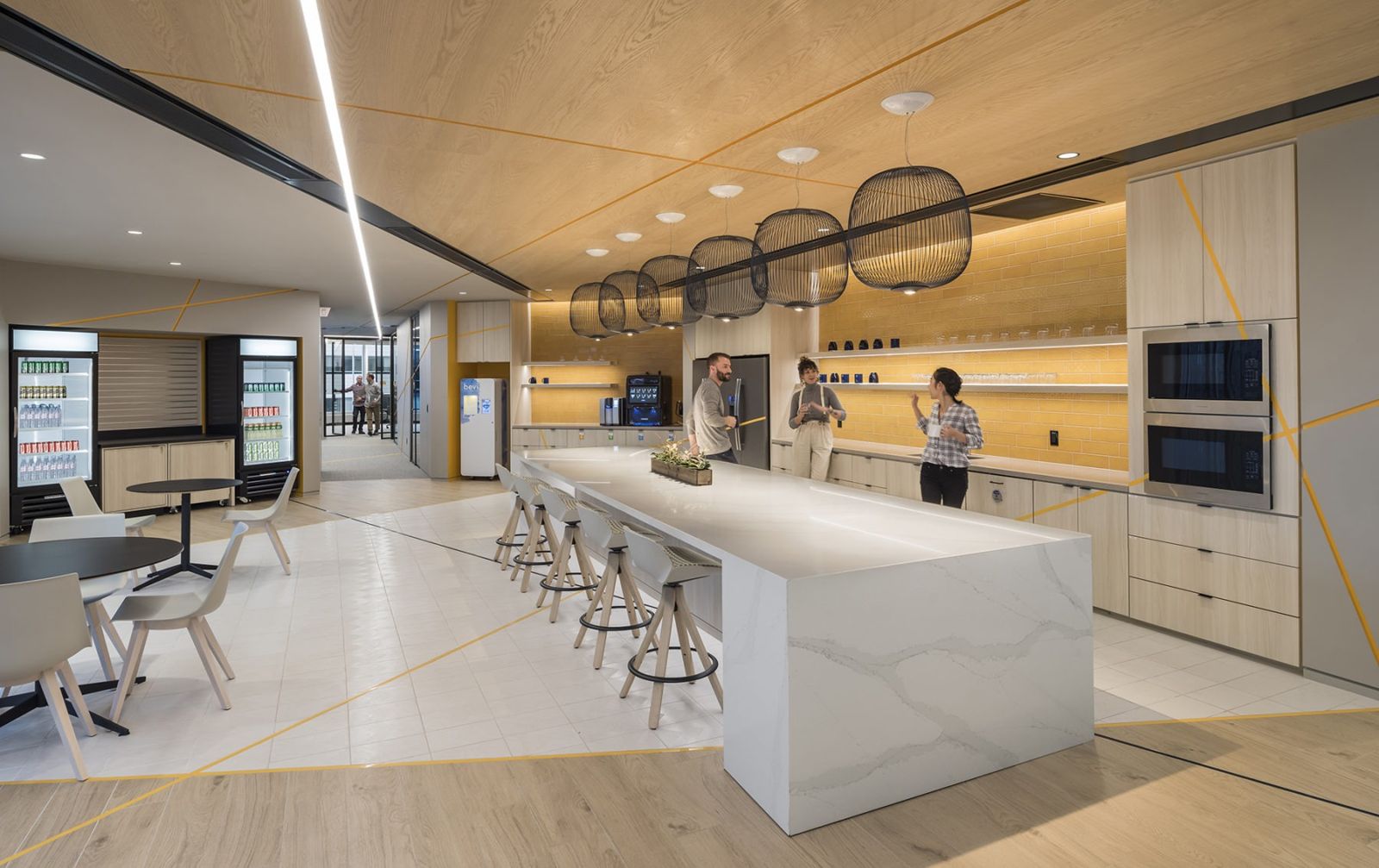 Akamai: A long white kitchen island with stools