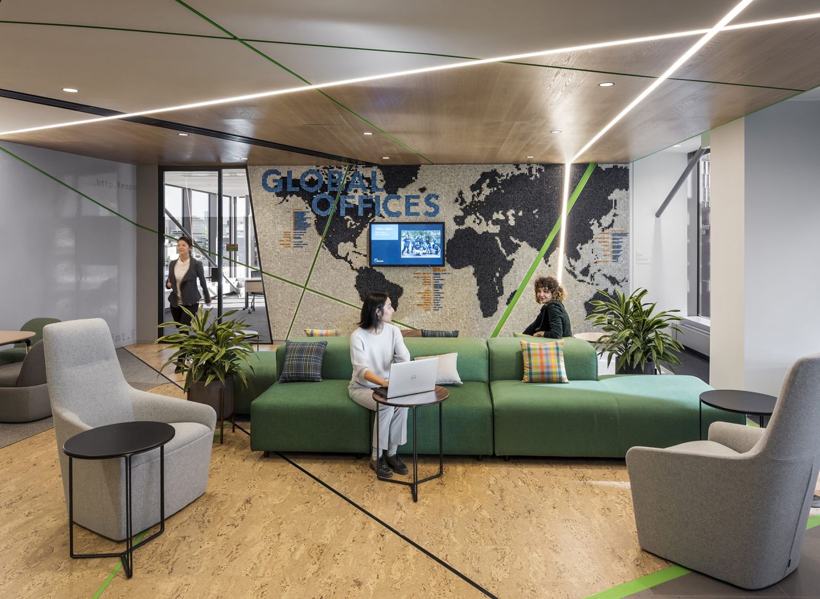 Akamai: Green sofa in front of a map of global offices