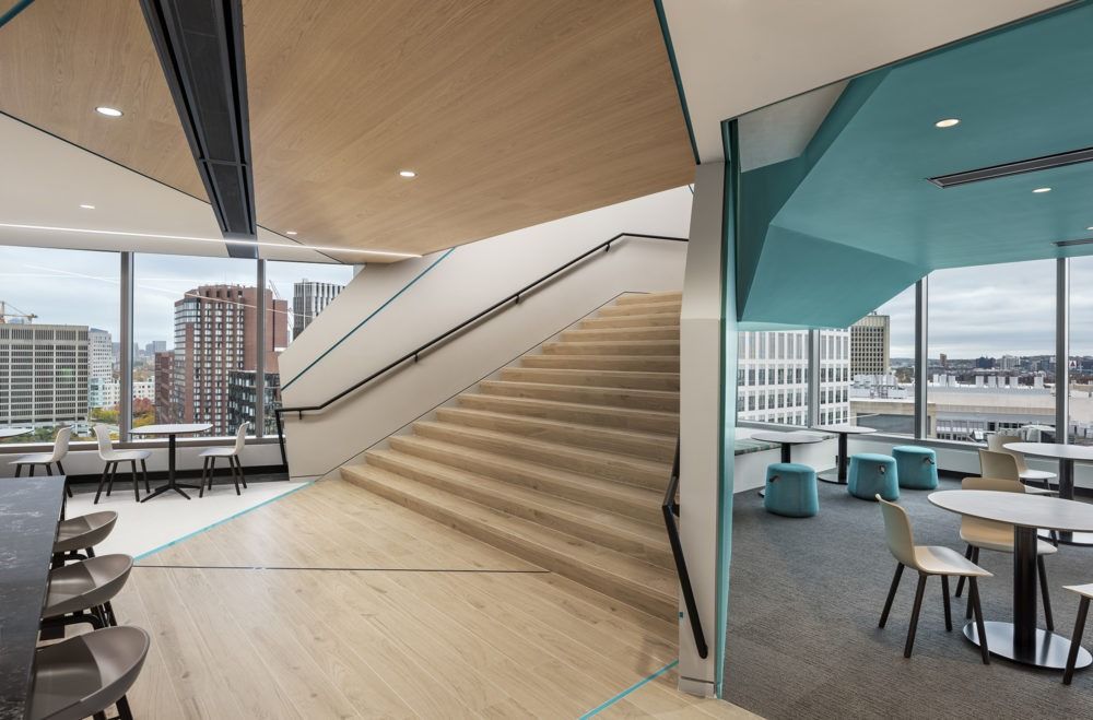 Akamai: Stairs rising beside a café with teal walls