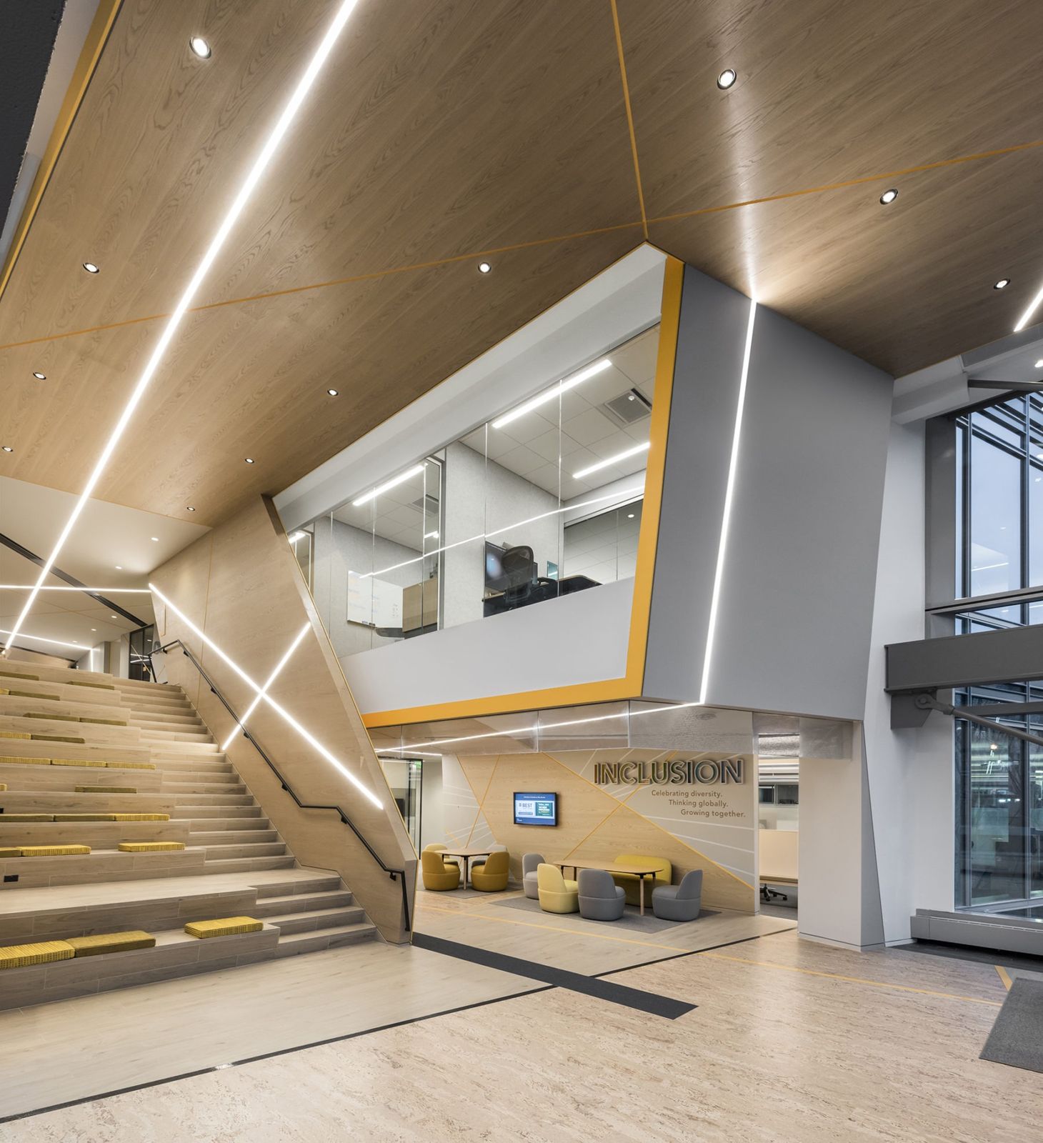Akamai: Wide stairs under a wood ceiling leading to a glass-fronted room