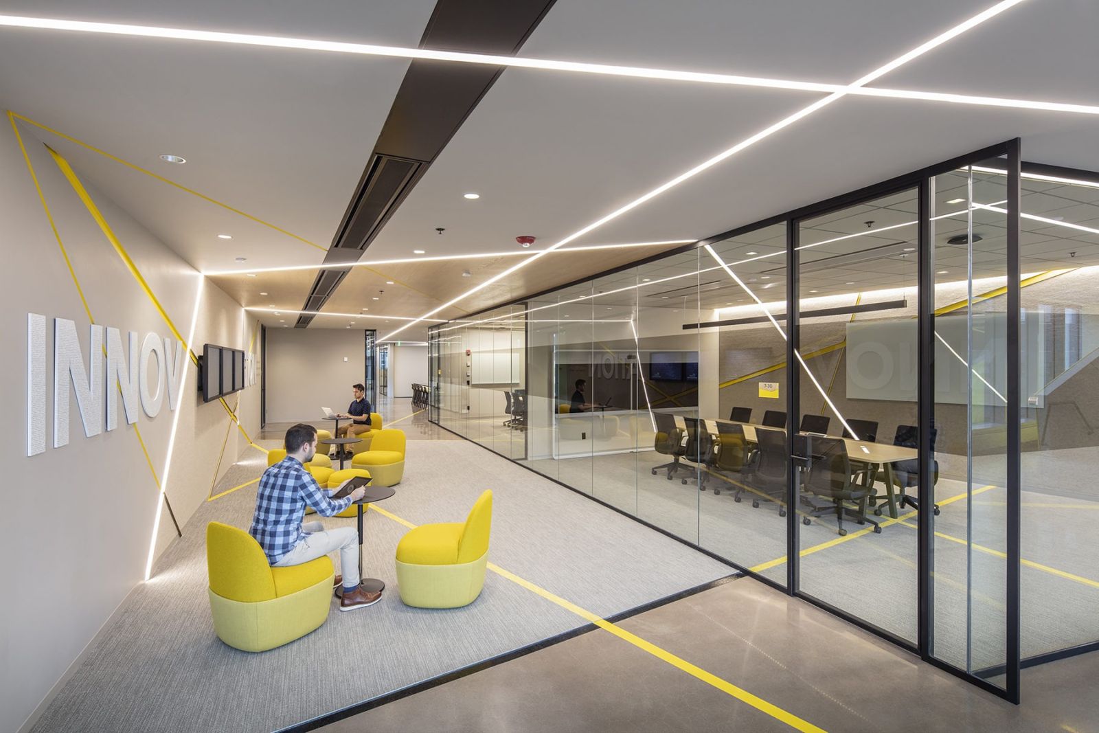 Akamai: Yellow chairs in front of glass meeting rooms