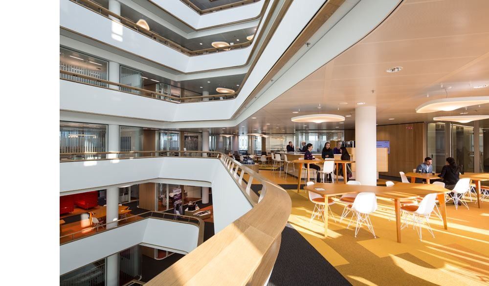 AkzoNobel: Atrium balconies with timber handrails and work tables on several levels