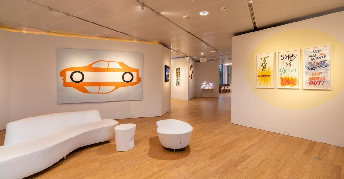 AkzoNobel: Gallery with a painted car artwork, framed posters and white seating