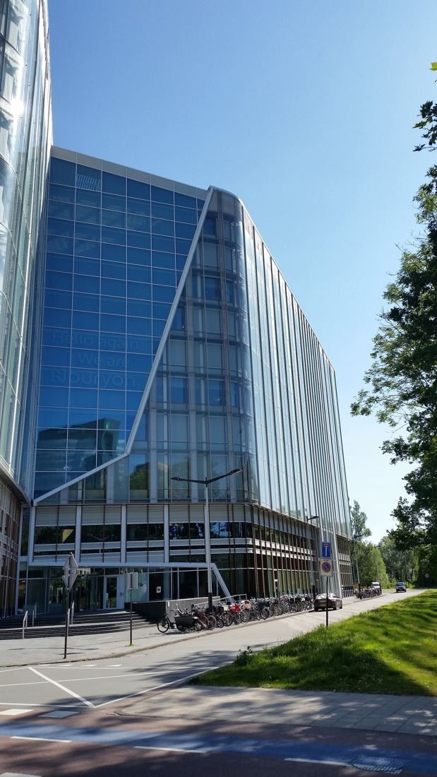AkzoNobel: Glass office building with a diagonal fold in its façade along a quiet street