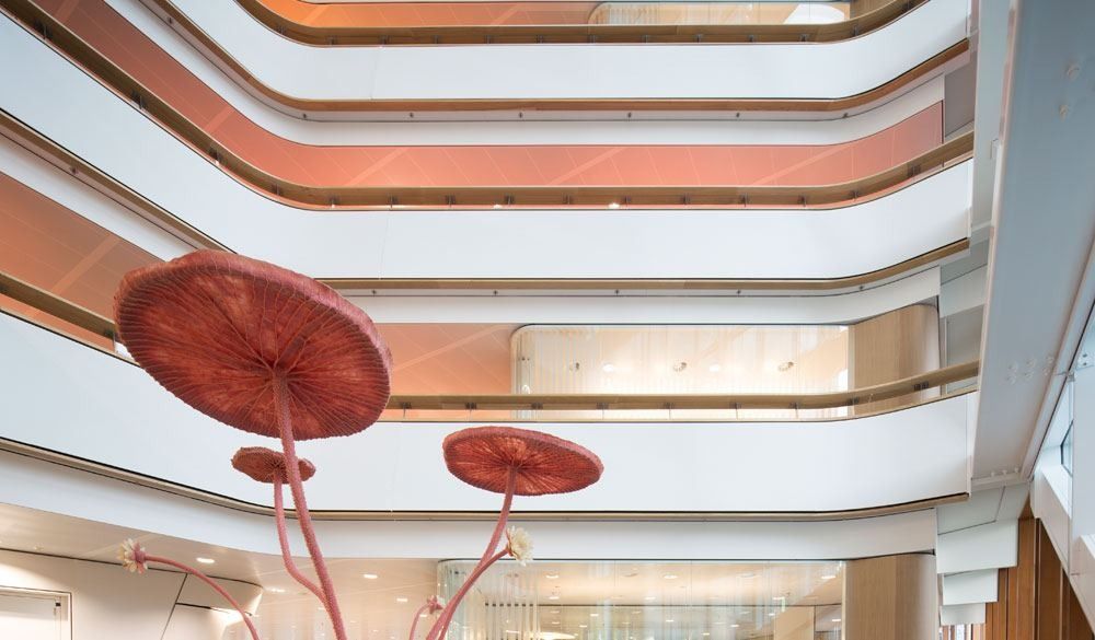 AkzoNobel: Tall white atrium with curving balconies and red mushroom-shaped sculptures