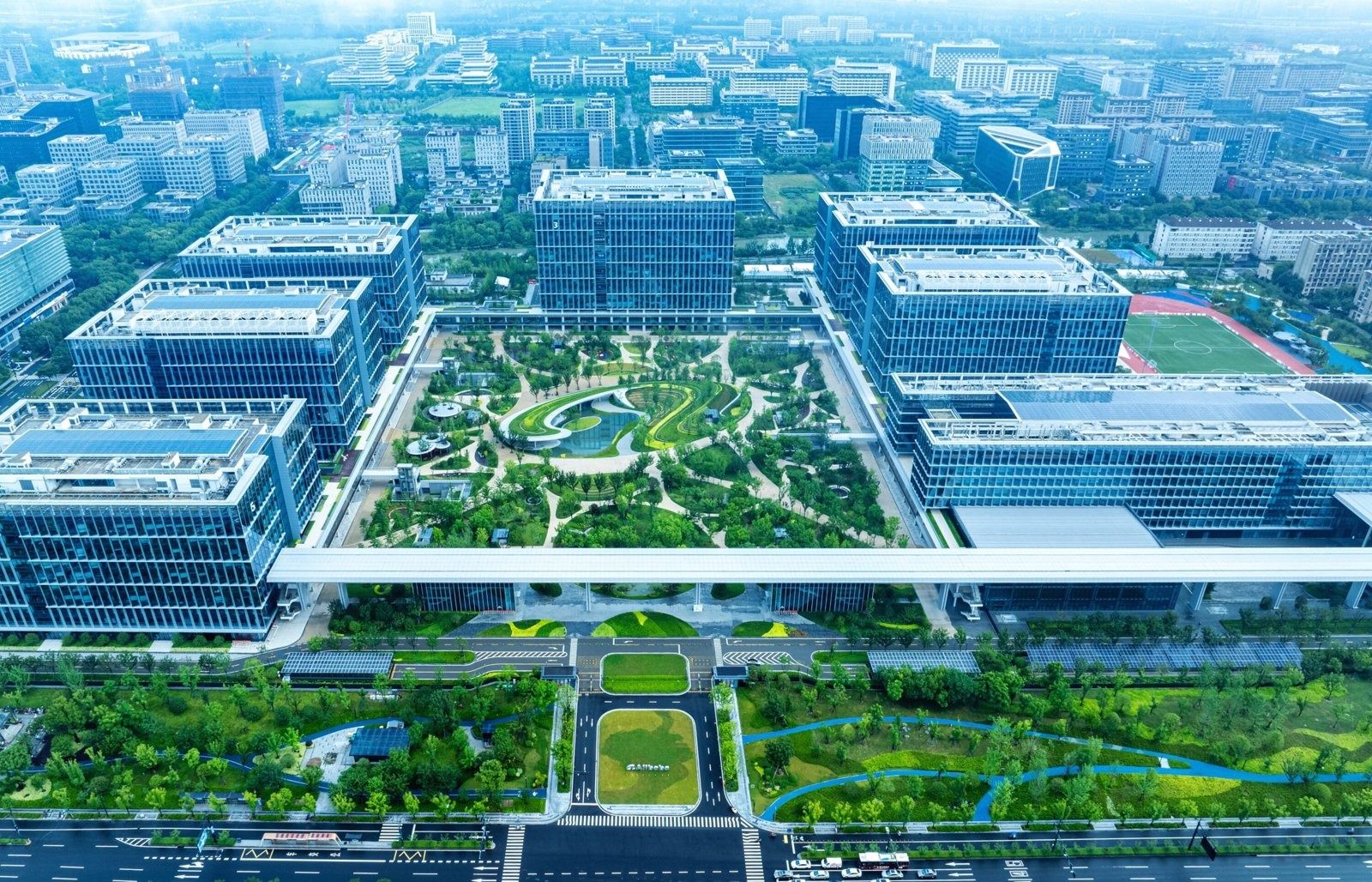 Aerial view of office buildings around a large central garden