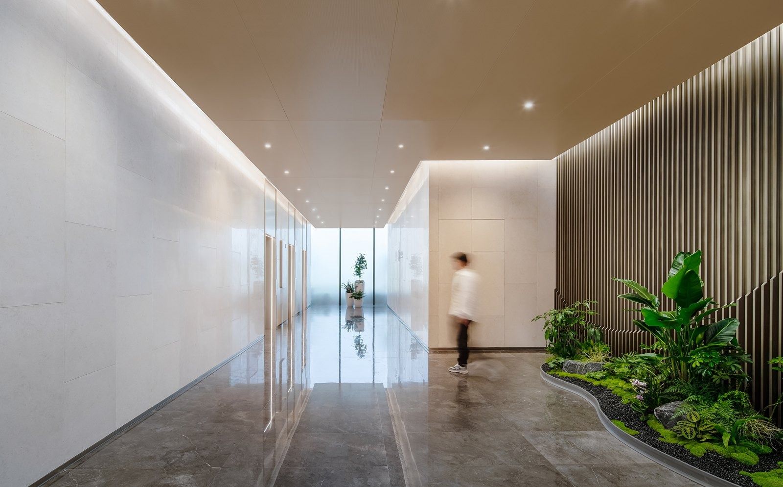Alibaba Group: Corridor with a stone wall and indoor plants