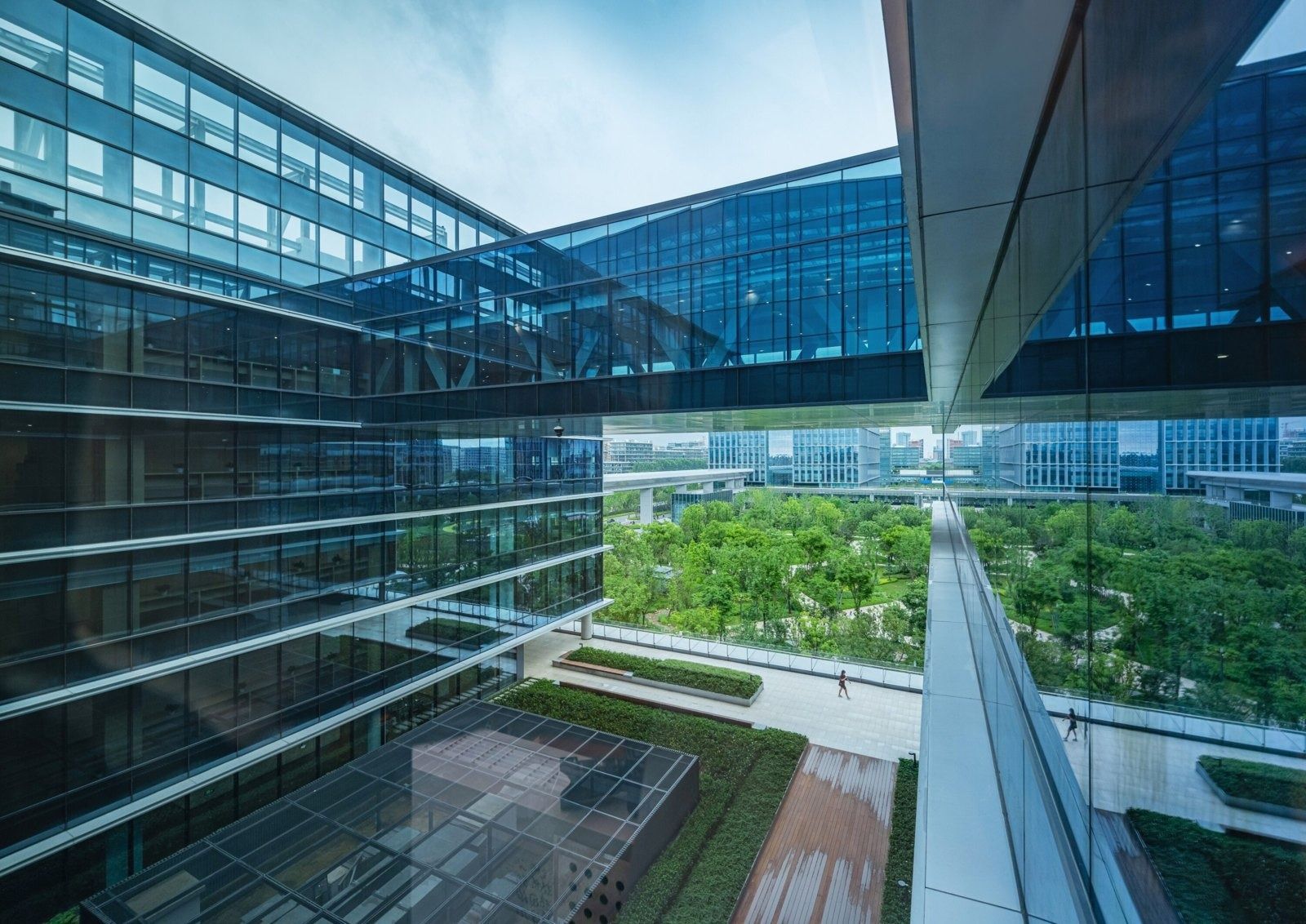 Alibaba Group: Glass bridge between buildings above a courtyard garden