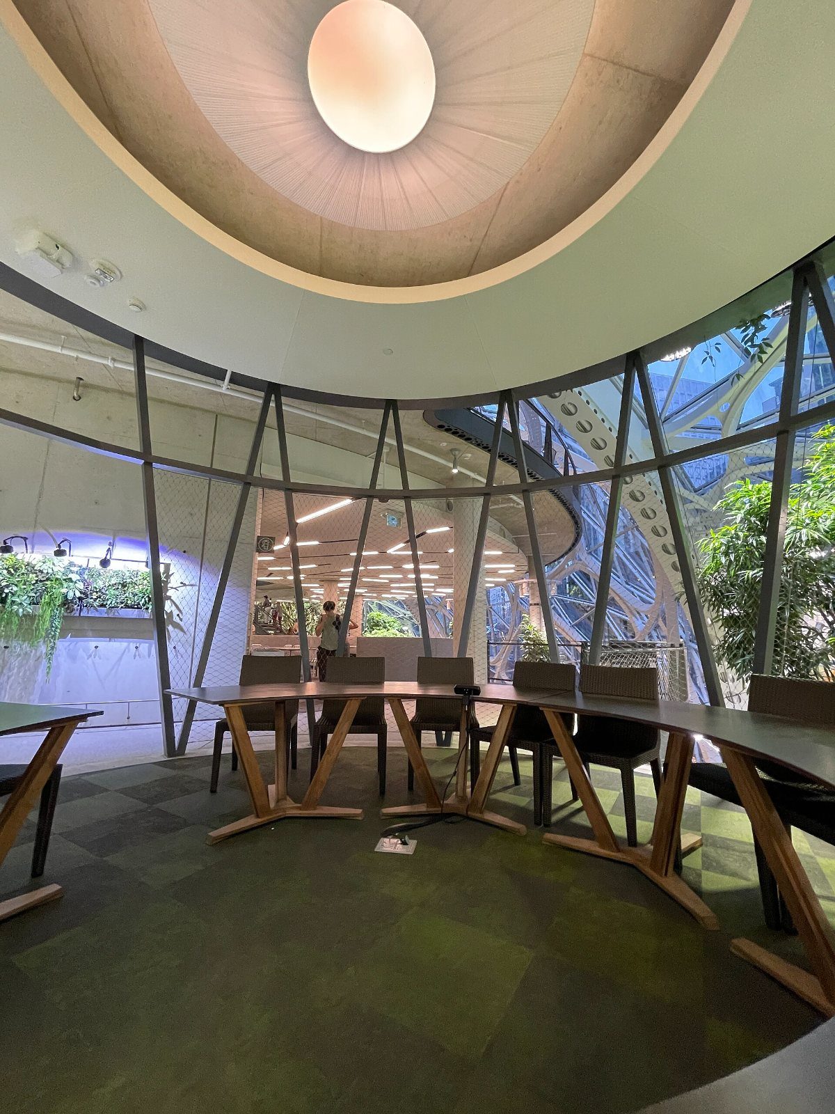 Round seating area under a glowing ceiling