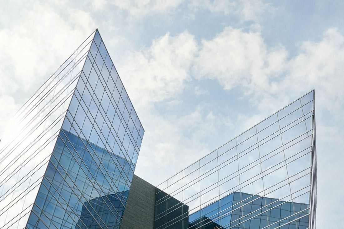 American Airlines: Close view of sharp glass building corners against a cloudy sky
