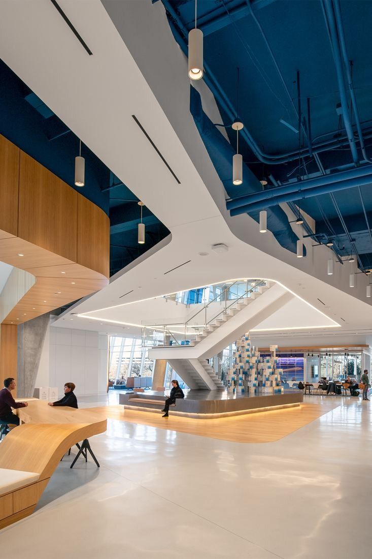 American Airlines: Multi-level interior with white stairs, wood surfaces and a blue ceiling