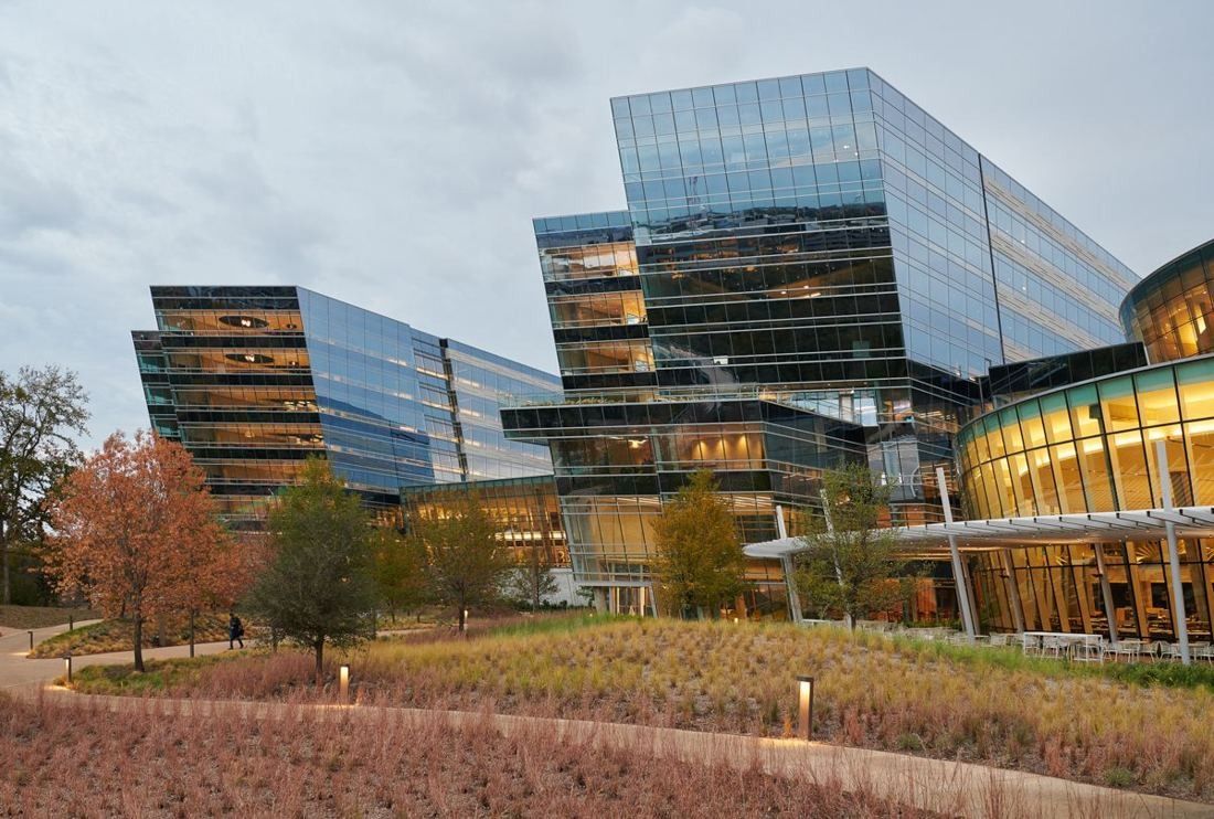 American Airlines: Stacked glass office blocks behind a planted meadow with autumn trees