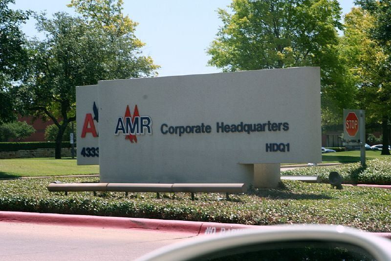 Stone sign reading AMR Corporate Headquarters HDQ1 in front of trees
