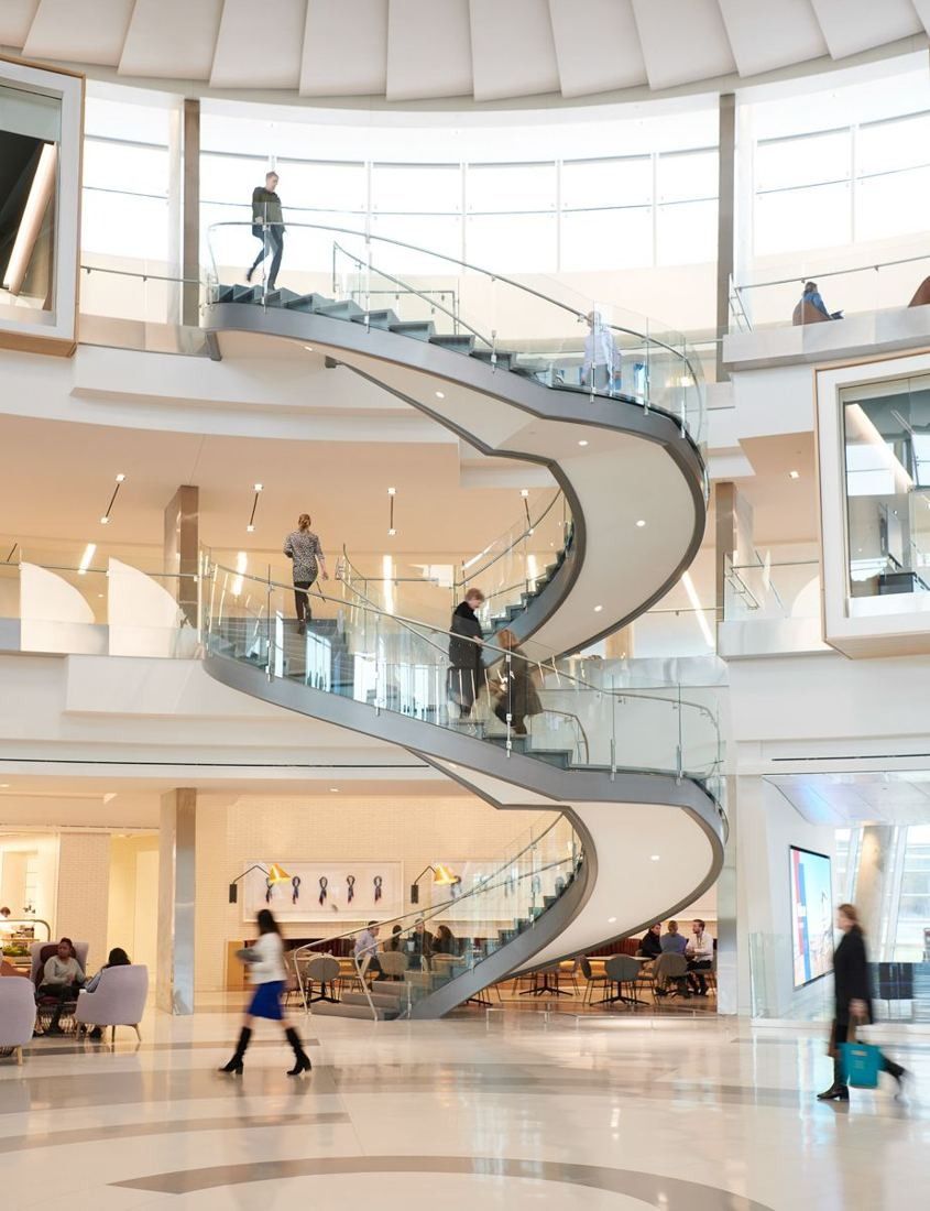 American Airlines: White spiral staircase rising through a bright open interior