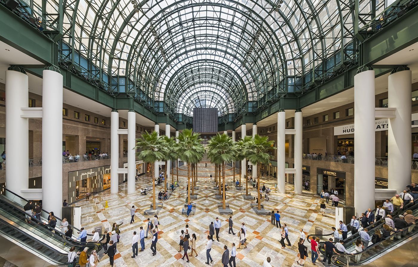 American Express: Glass-vaulted atrium with palm trees and marble floor