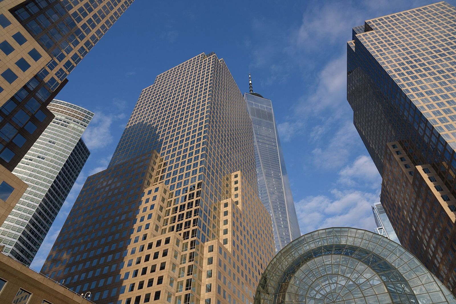 American Express: Tower with a pyramid top seen from below beside a glass vault