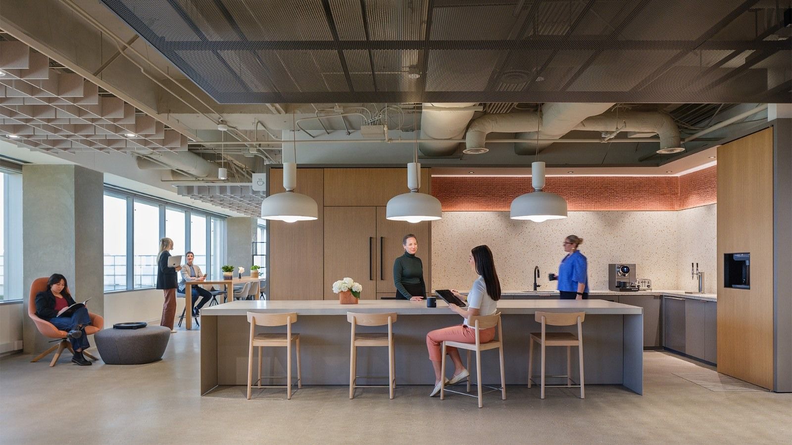 APA Corporation: A bright pantry with an island and stools under pendant lamps
