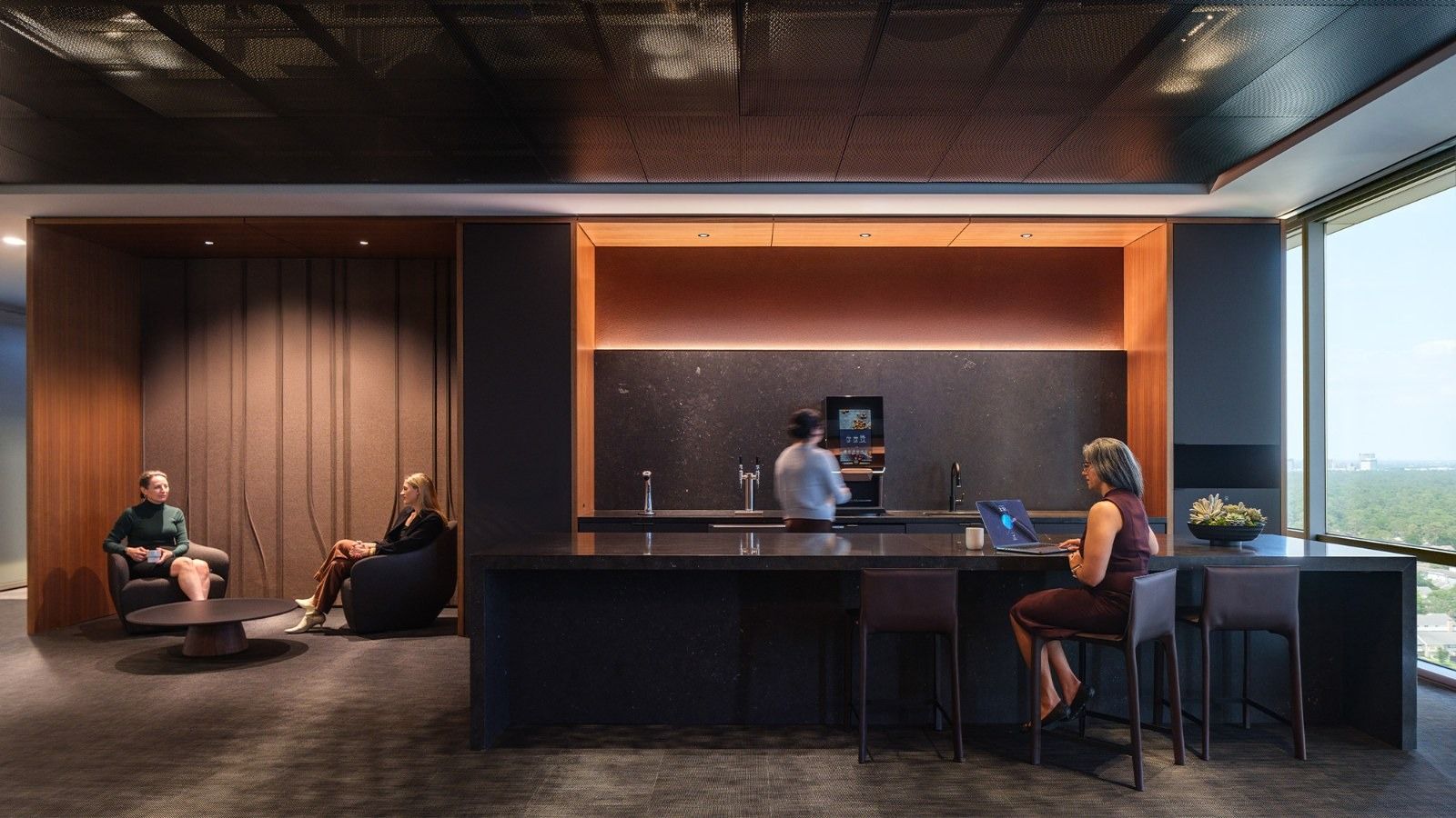 APA Corporation: A dark kitchen and bar with an orange-lit wall