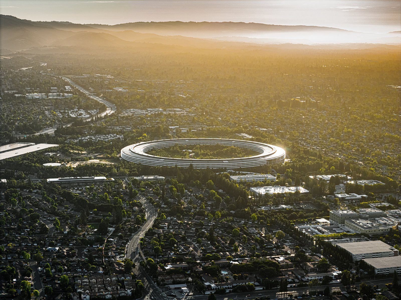 Apple: Aerial view of the ring building at sunset