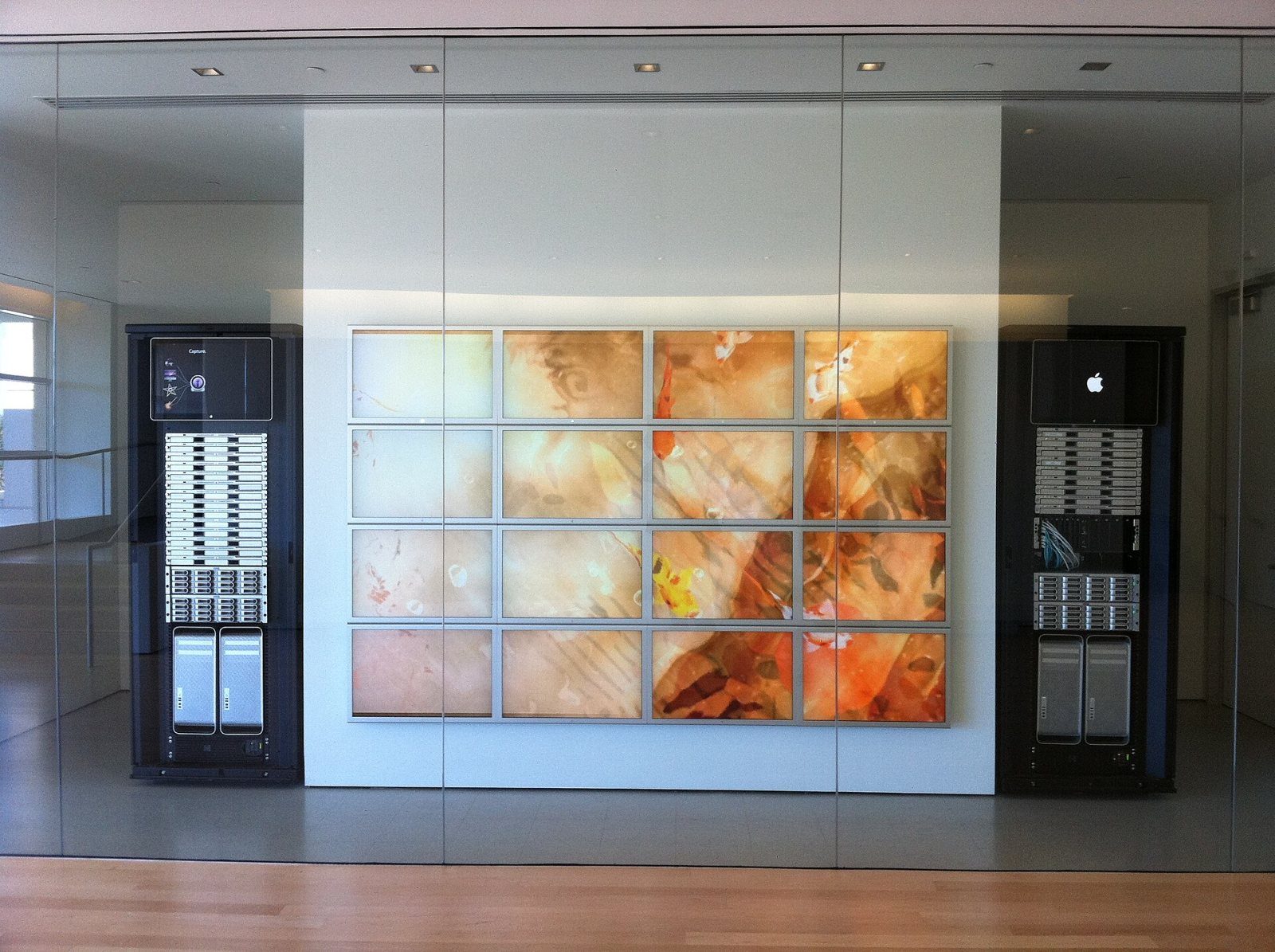 Apple: Wall of screens between dark server cabinets