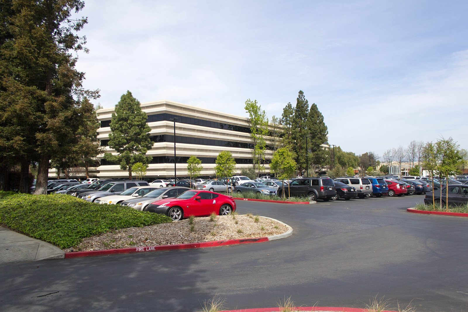 Apple: Long low office building behind a car park
