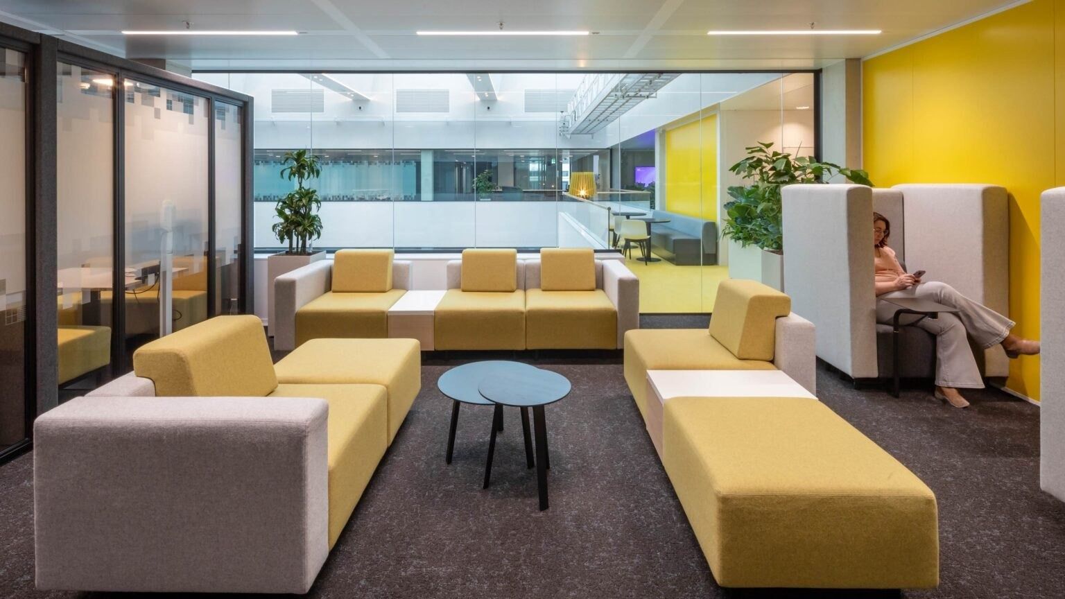 A yellow-walled lounge with sofas