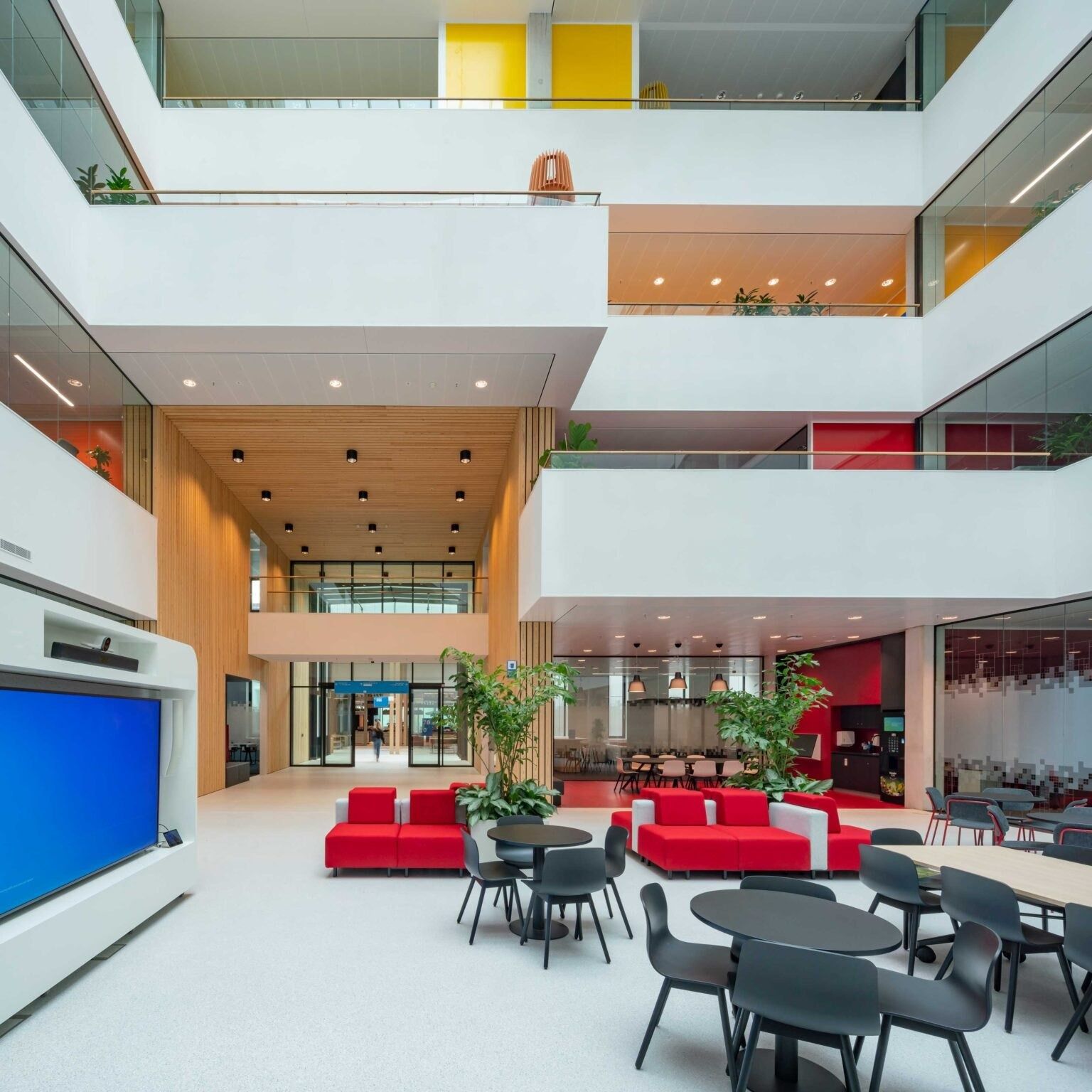 An atrium with a blue wall and seating