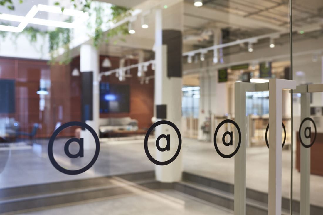 ASOS: Glass partitions with circular logos in front of a seating area