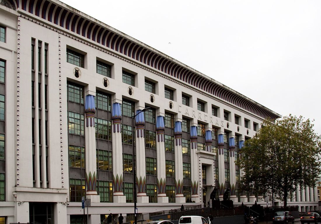 ASOS: Long white facade with rows of decorated columns and dark window bands