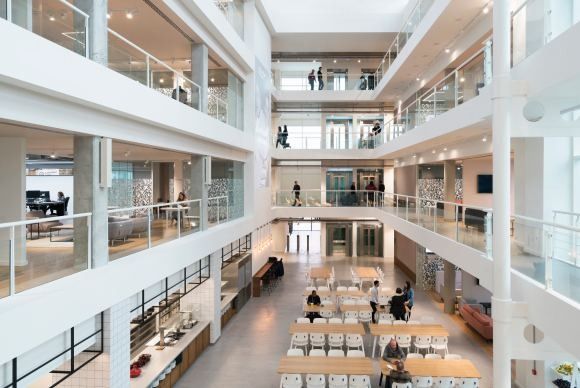 ASOS: Multi-storey white atrium with balconies on every level and seating on the ground floor