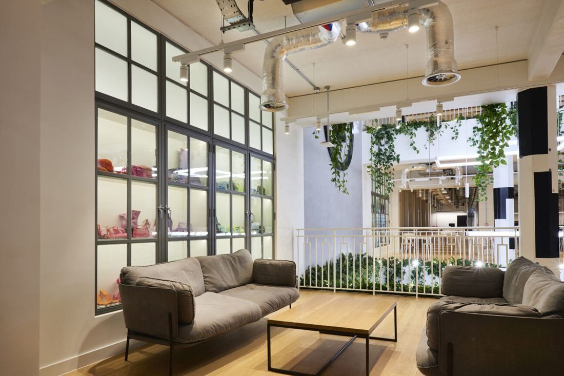 ASOS: Sofas beside steel-framed windows with plants and white railings