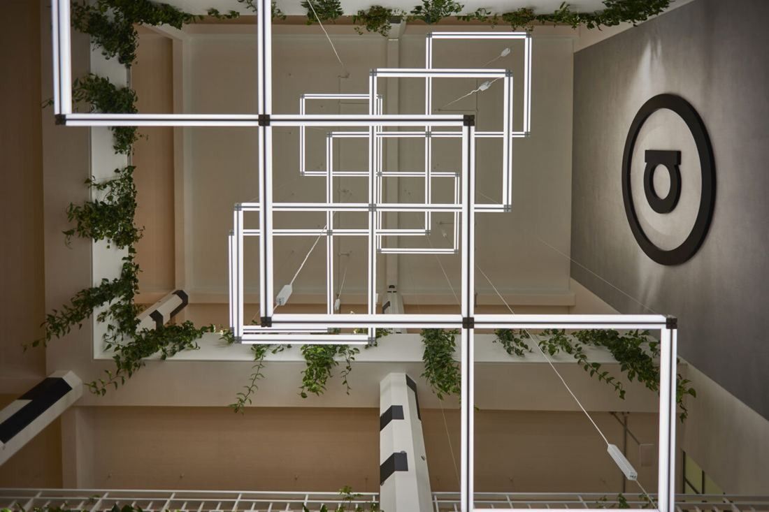 ASOS: View up into the atrium through layered rectangular light fittings