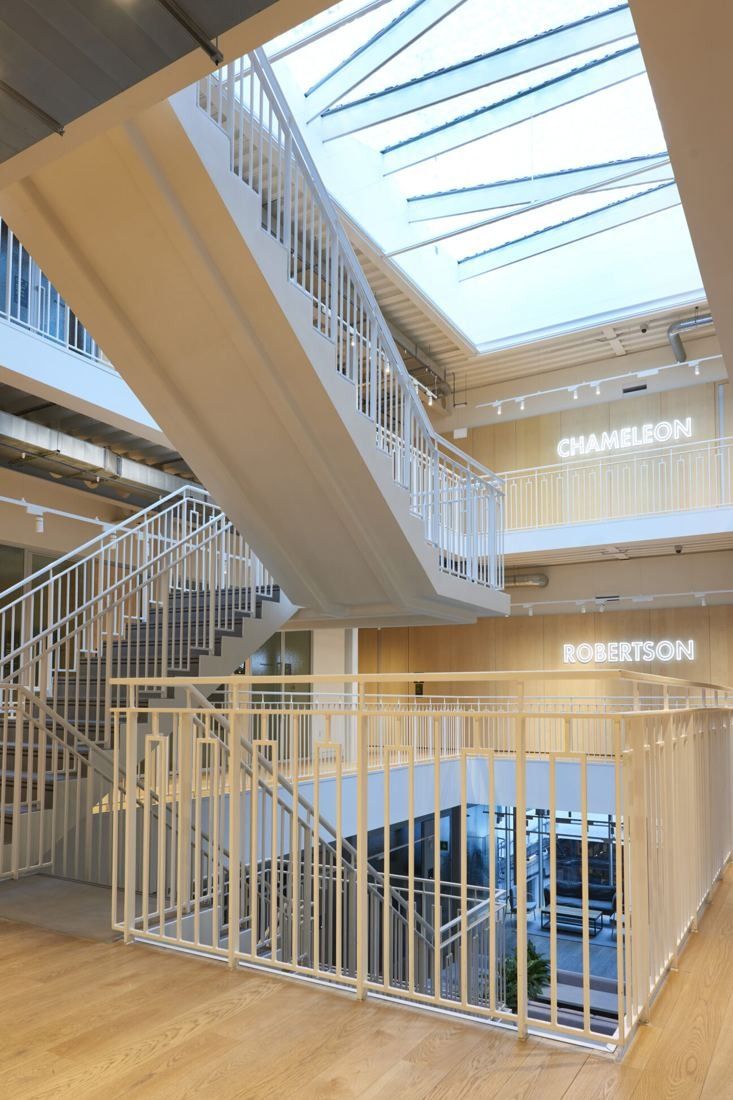 ASOS: White stairs rising through several floors under a skylight