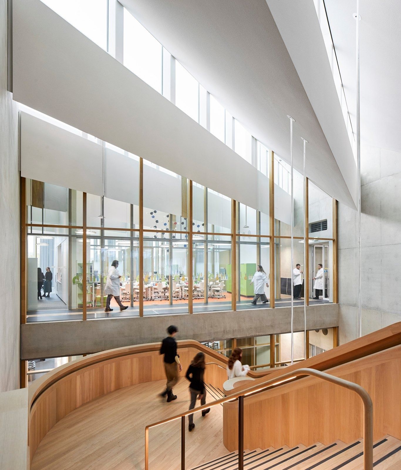 AstraZeneca: Curved wooden stair rising along a glass wall