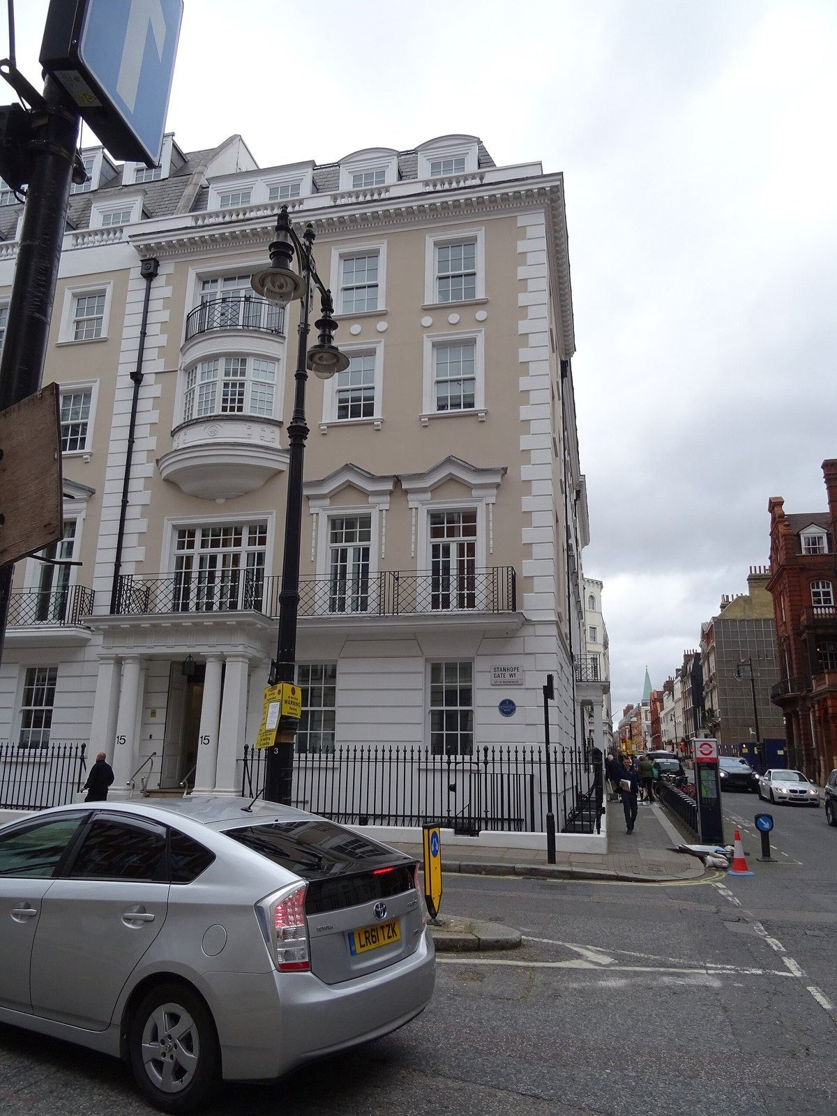 White stucco townhouse on a street corner