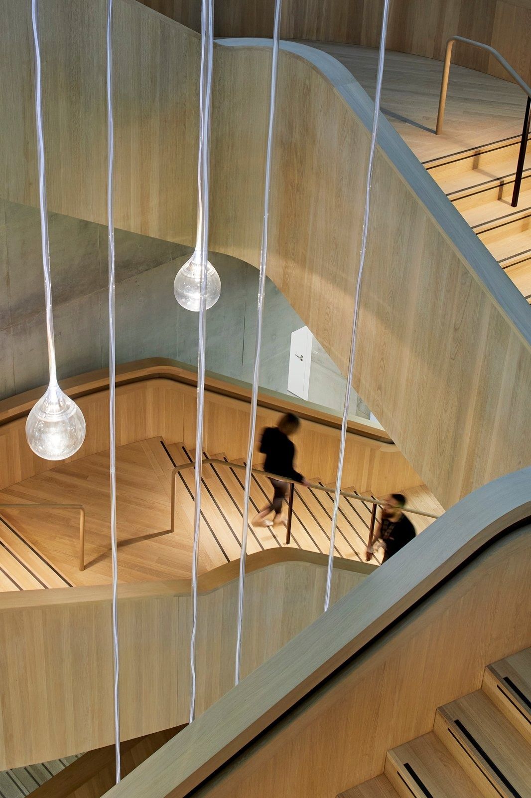 AstraZeneca: Wooden spiral staircase with hanging pendant lamps