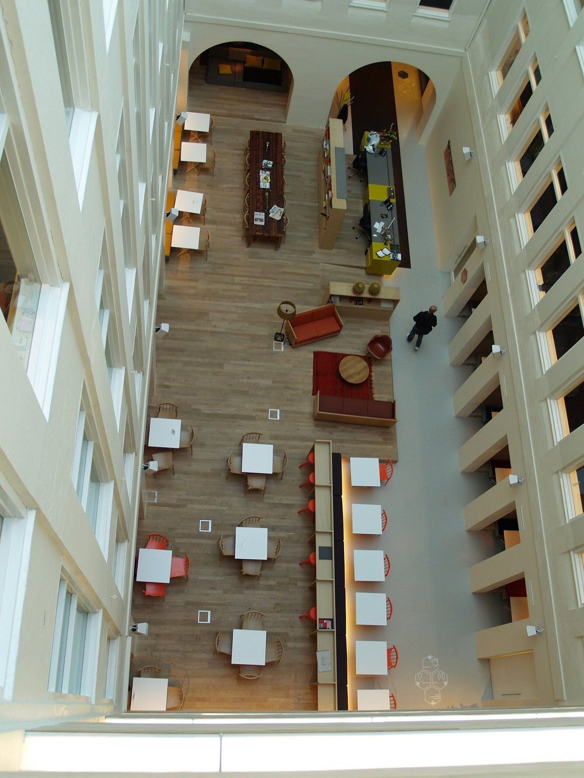Atlassian: A long atrium floor with tables